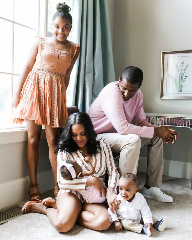 Mom and dad pose with their children
