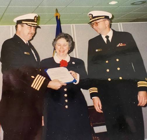 Jackie and her husband receive a certificate of recognition as they near the end of her husband’s service.