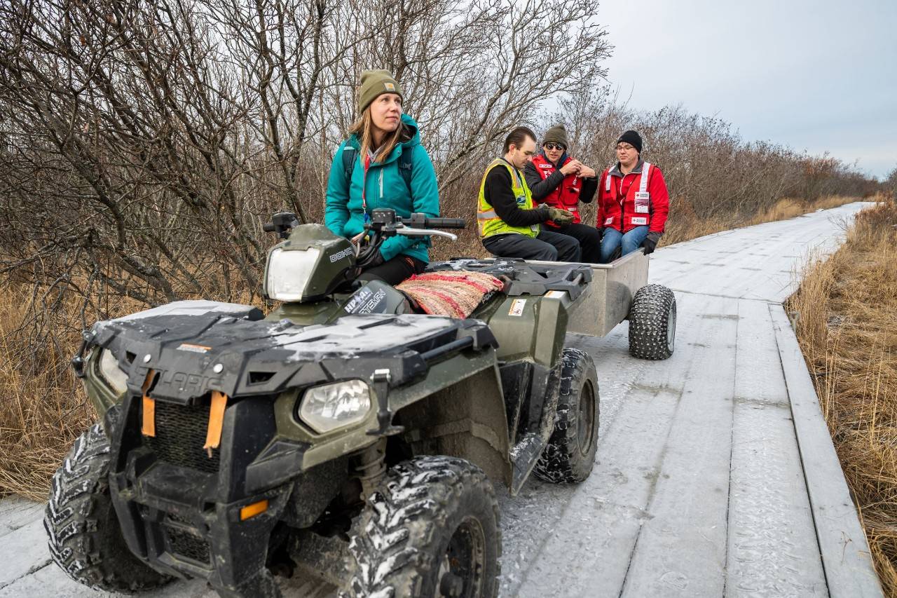 Several people on a four-wheeler in Alaska