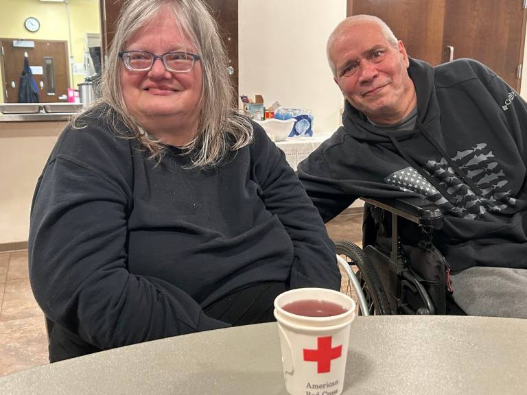 Two women and a man sit at a table