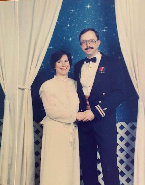 Jackie and her husband take a portrait when they were young. Both are smiling. 