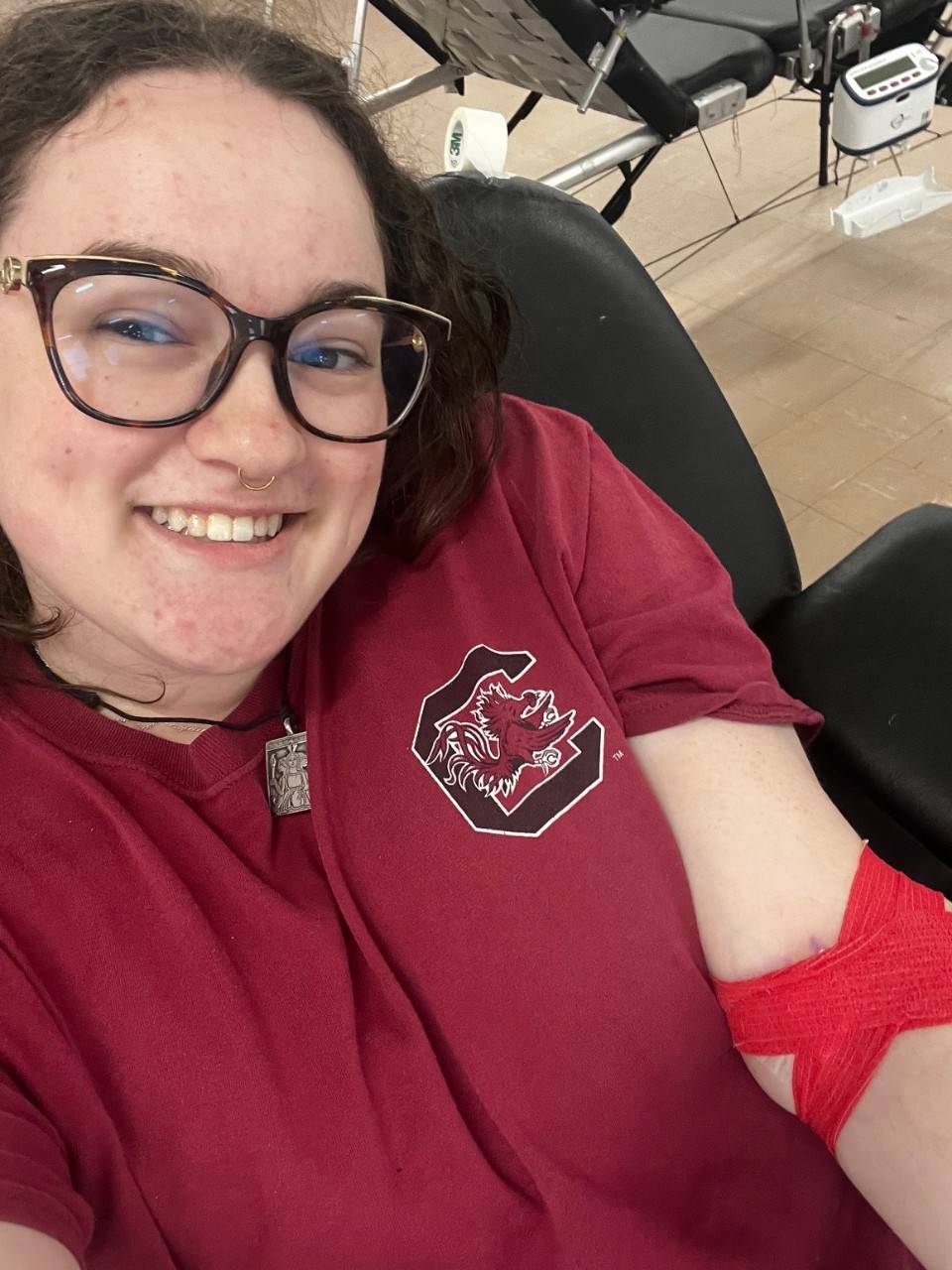 Woman with bandaged arm after giving blood