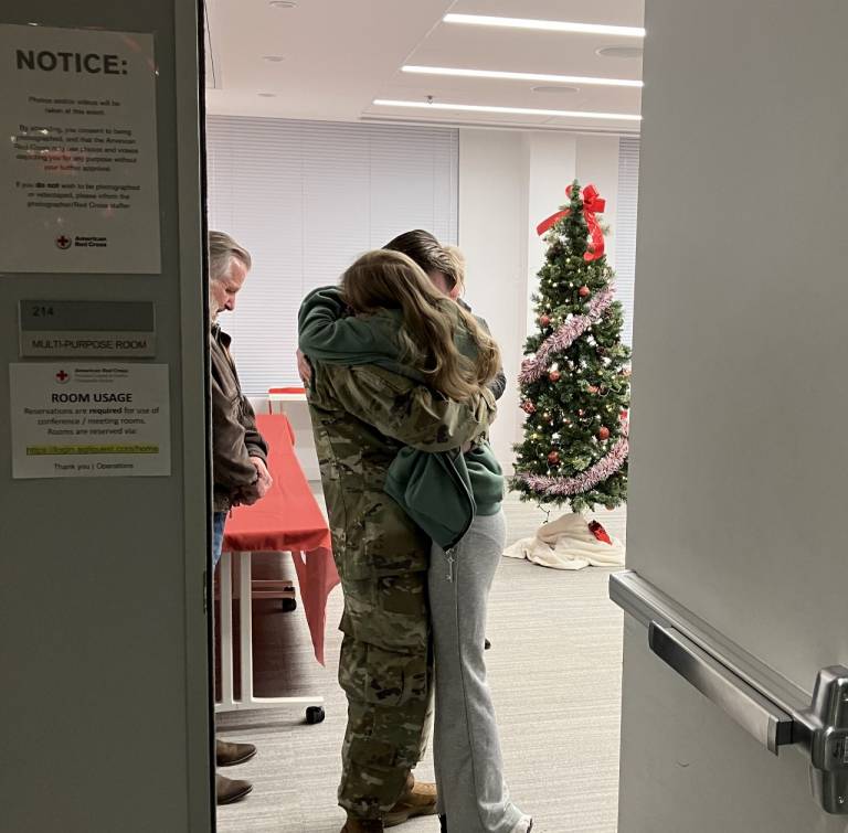 Soldier hugs his sister