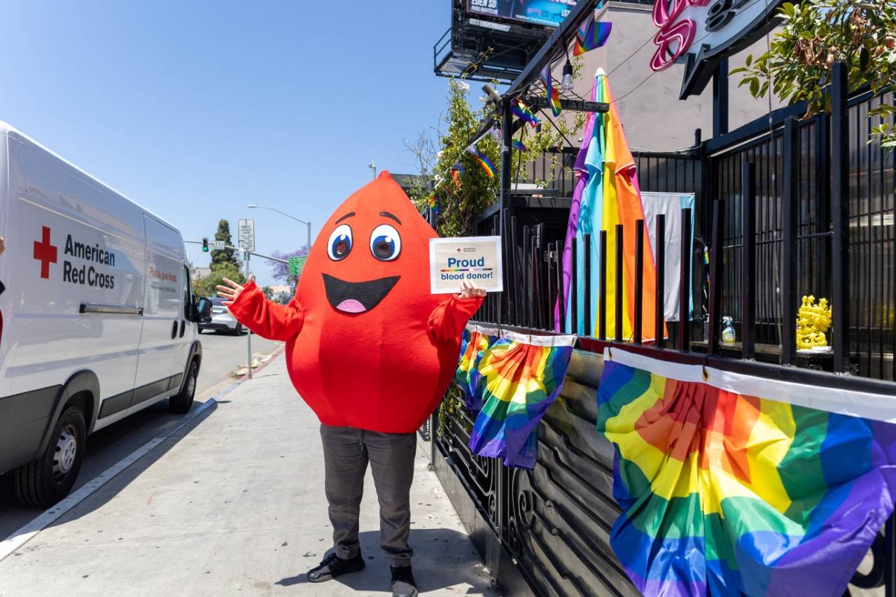 Mascot Buddy the Blood Drop stands outside a Gossip Grill Blood Drive.