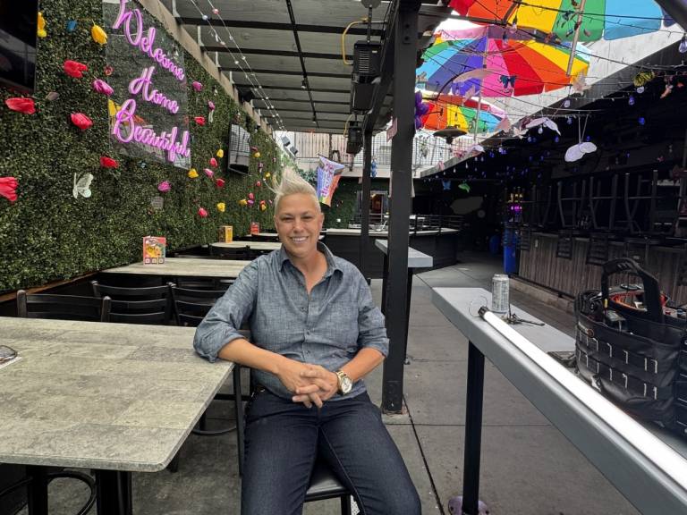 Gossip Grill owner Moe Girton sitting on the bar patio.