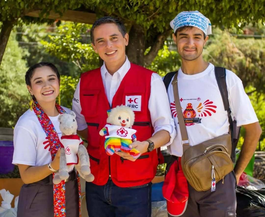 Two young men and a woman dressed in bright clothes