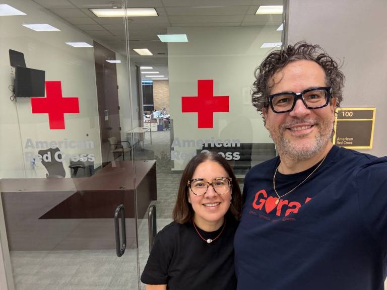  two Red Cross volunteers smile together
