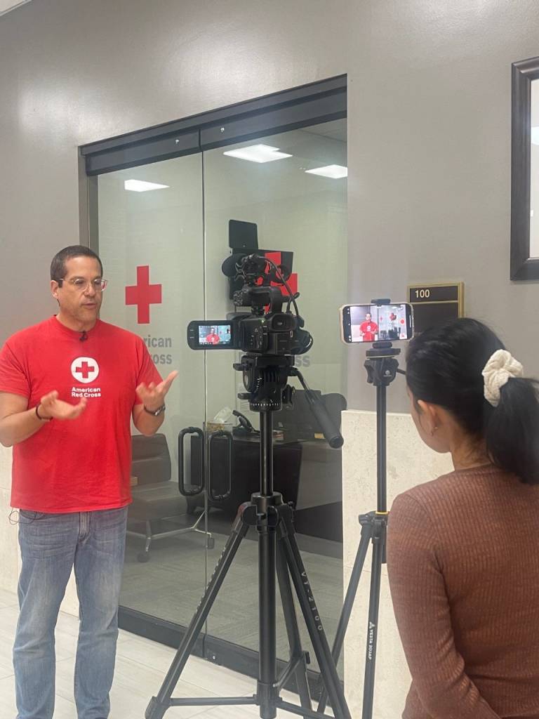 Red Cross volunteer giving a news interview