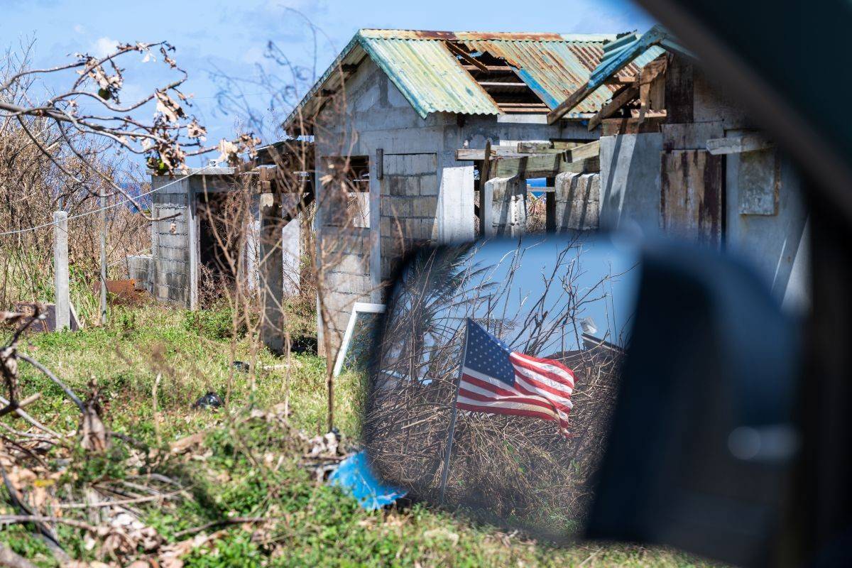Buildings damaged by a storm, including holes in the roofs.