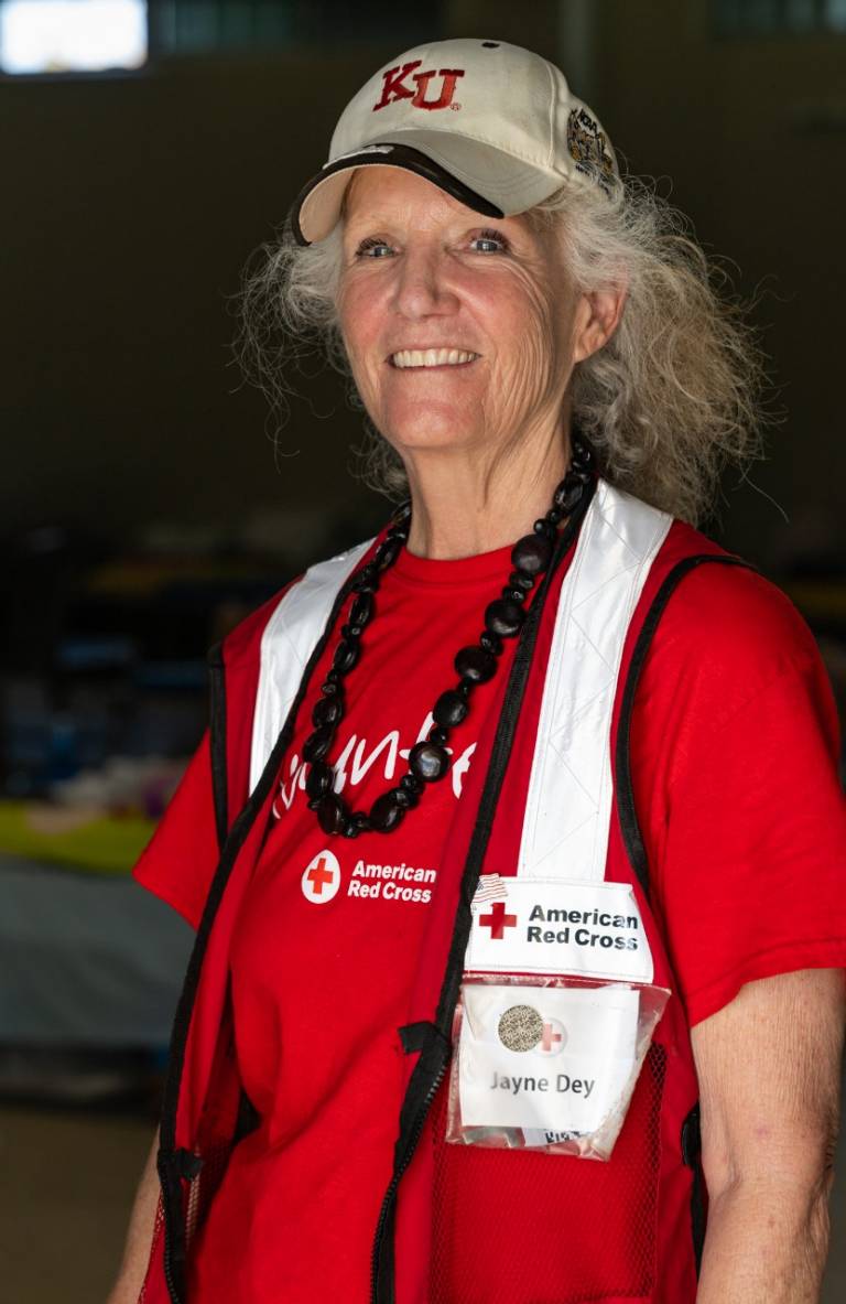 Woman in Red Cross shirt and vest.