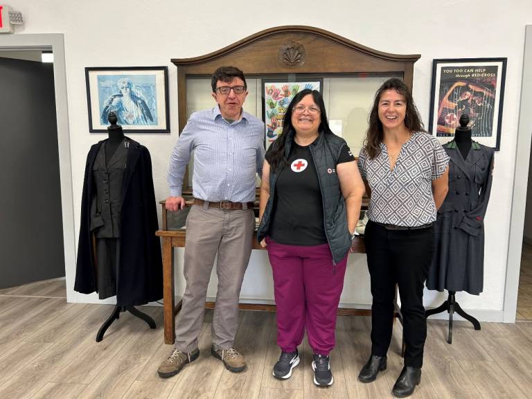A group of people stand in a line for a photo