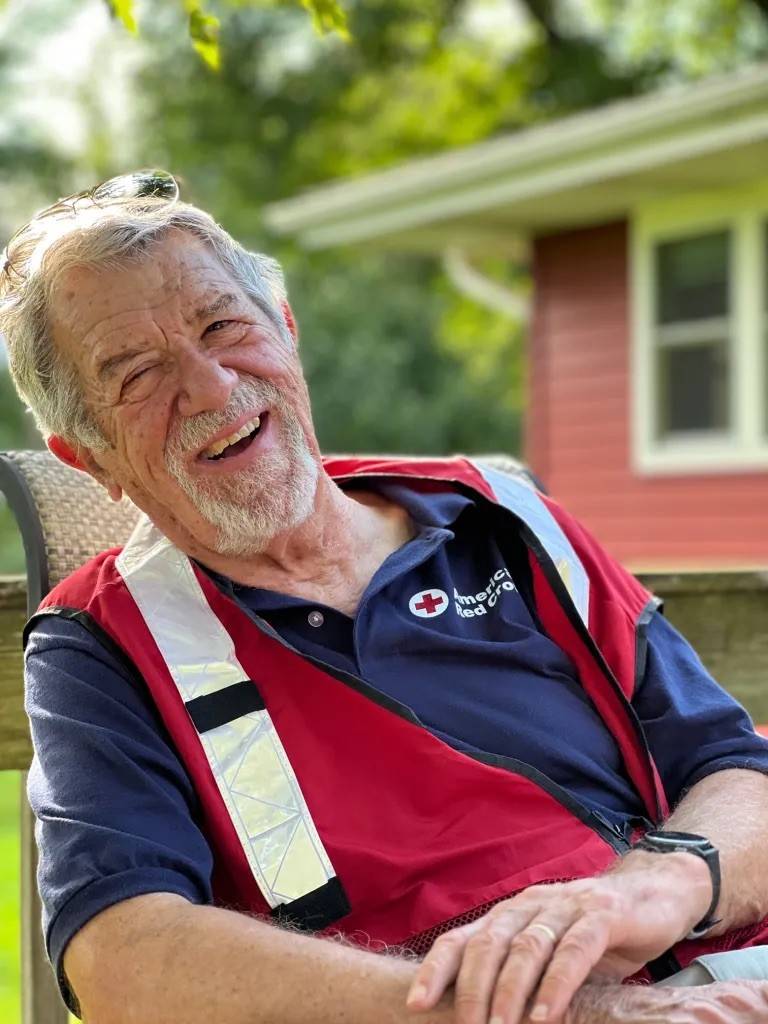 Man in Red Cross vest.