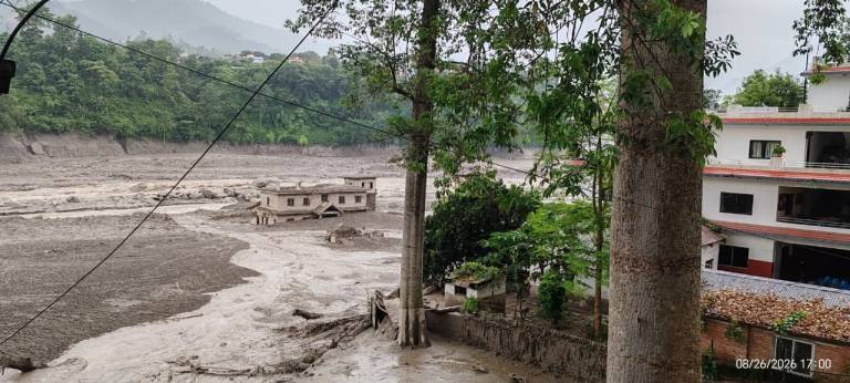 Brown mud can been seen where a community once stood along the banks of the Bhote Koshi River. 