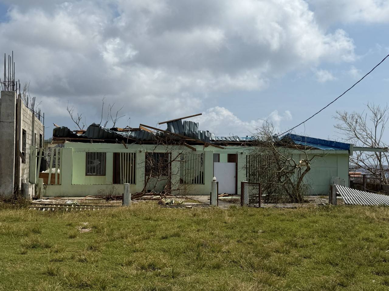 A building with its roof heavily damaged.