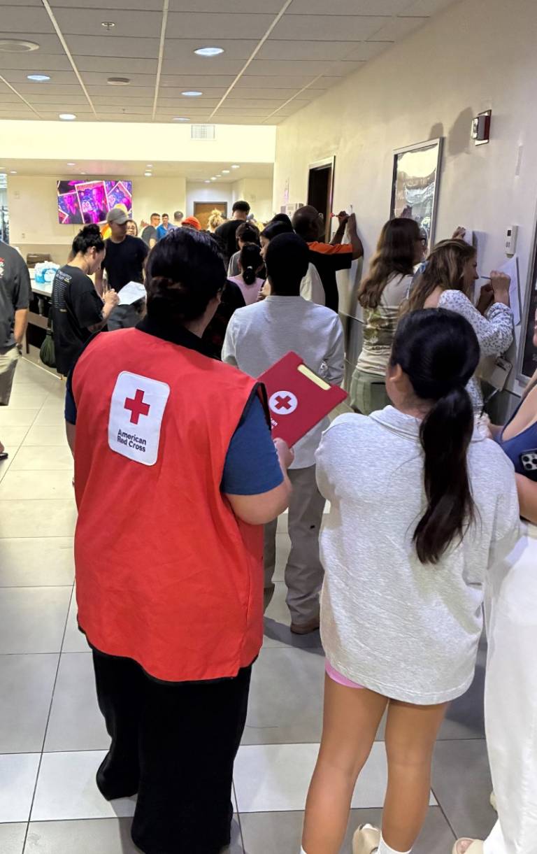 People line up as Red Cross offers help at an Emergency Family Assistance Center on Naval Base Guam. 