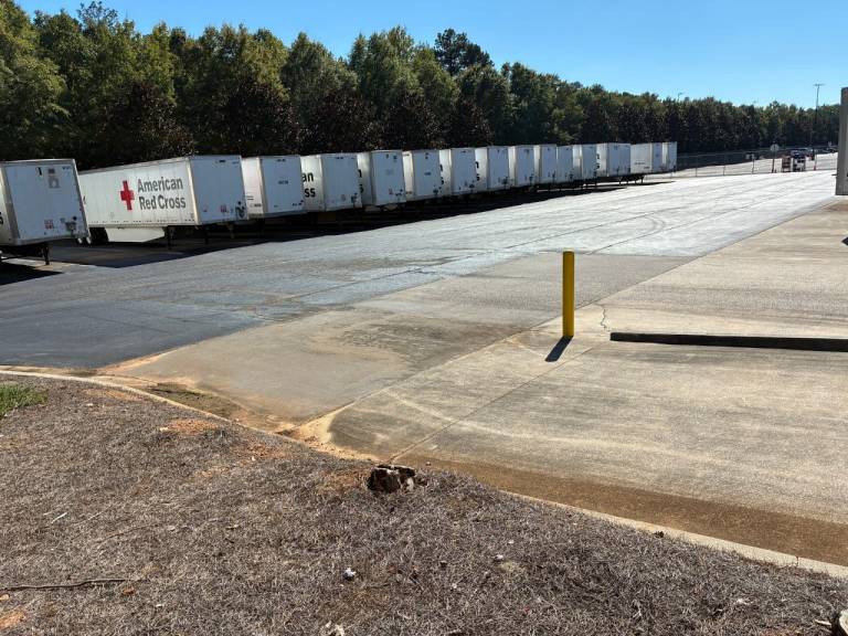 Trailers with the Red Cross logo sit parked.