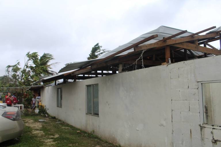 A building with its roof heavily damaged