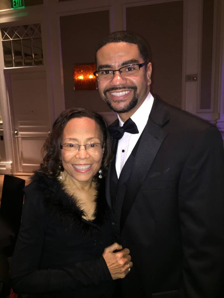  Patricia McGill and her son Crawford stand together, both smiling for the camera.