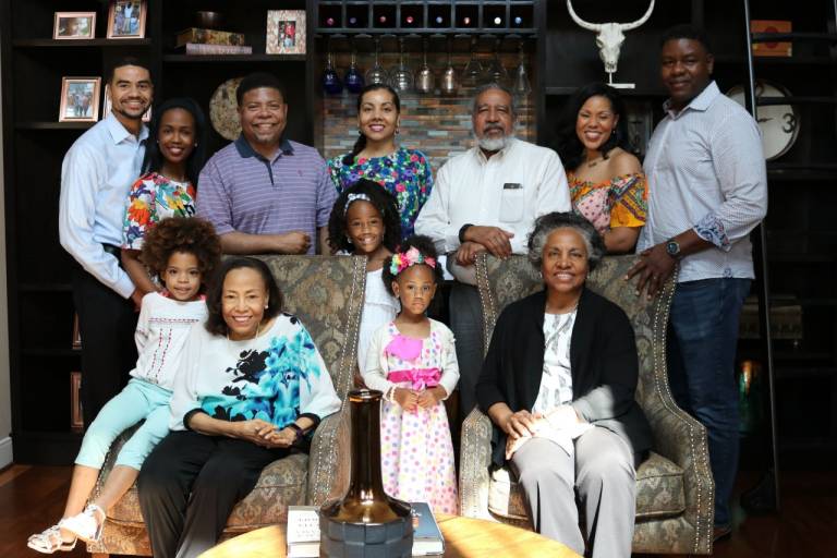  Patricia McGill surrounded by several generations of her family, seated among her children and grandchildren.