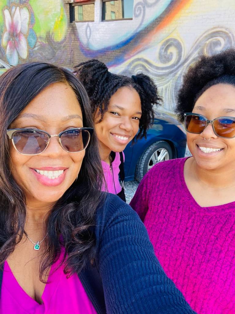 Asiya smiles with her daughters Sana and Jade