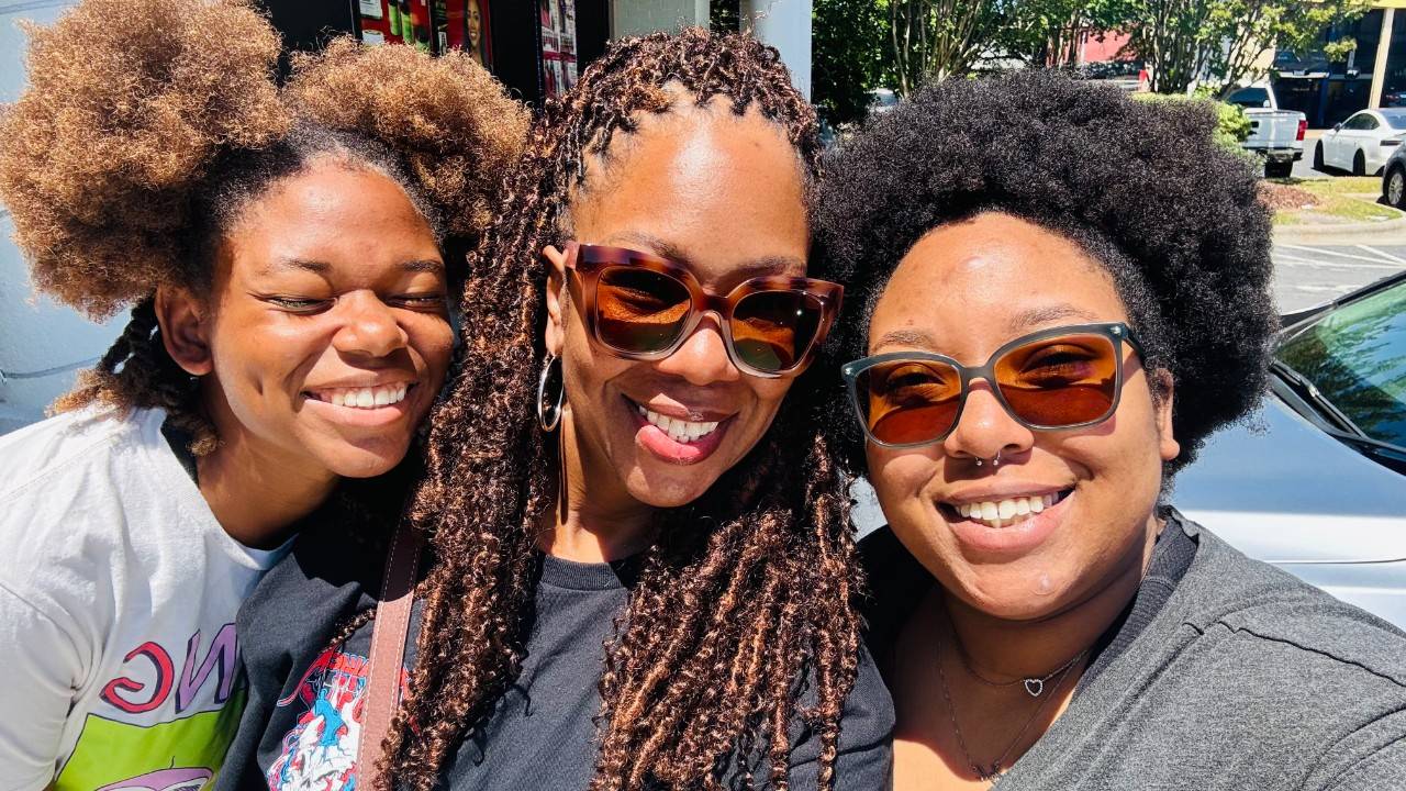 Asiya Khaatoon smiles with her daughters Sana and Jade.