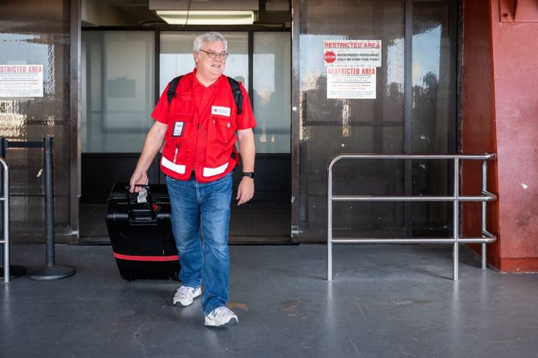 People arrive at an airport with their luggage