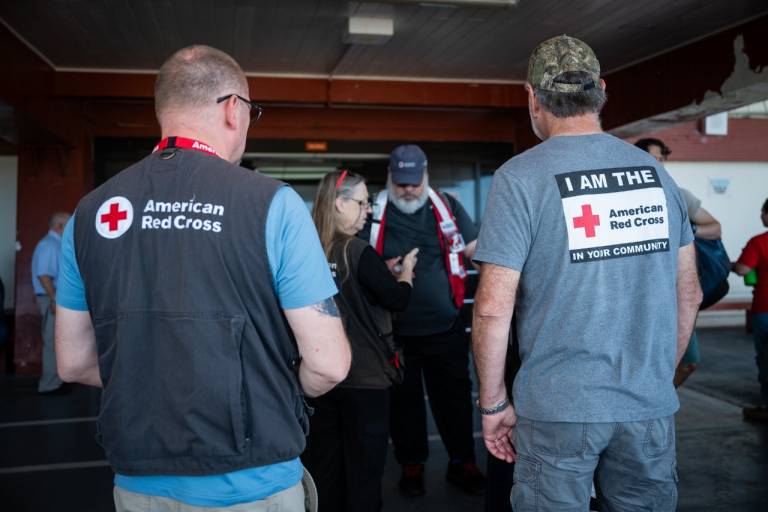 People arrive at an airport with their luggage