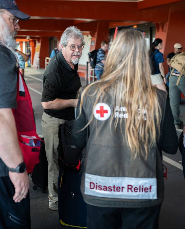 People arrive at an airport with their luggage
