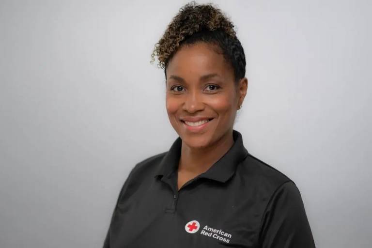 Dr. Angela K. Beale-Tawfeeq, associate professor at Rowan University and member of the American Red Cross Scientific Advisory Council, smiles while wearing a black American Red Cross polo shirt.