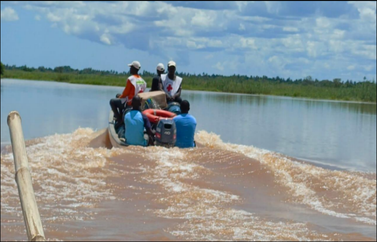 people in Red Cross vests aboard a boat
