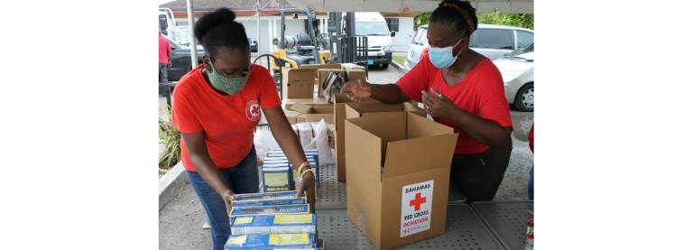 Bahamas Red Cross volunteers pack food boxes 