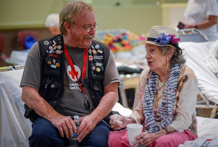 Red Cross volunteer Teddy Rhamy with 91-year-old shelter resident