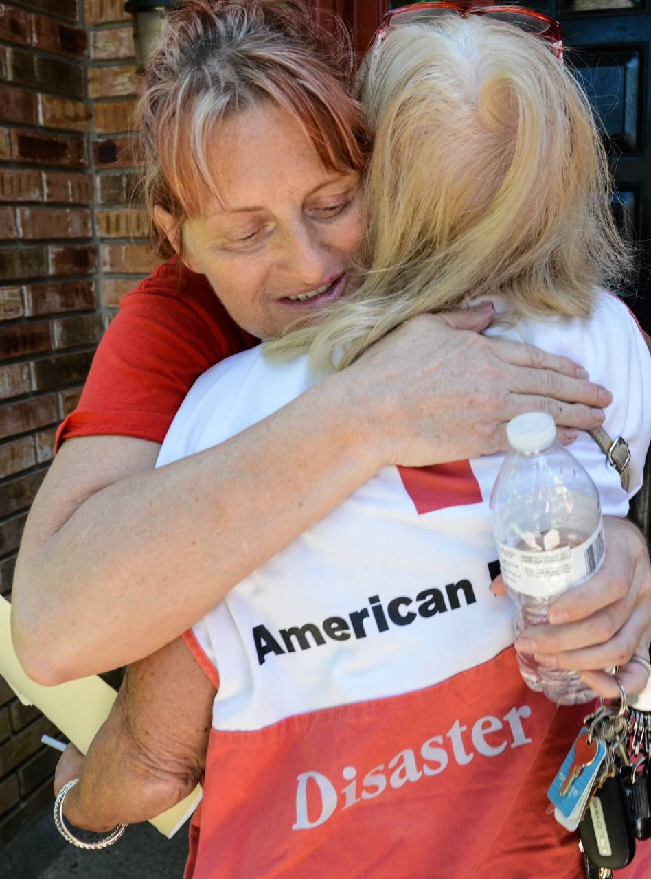 May 13, 2019. Houston, Texas. Disaster mental health volunteer, Shirley Jackson, hugs Lola Jones. Lola is letting her neighbor, Brenda, stay with her until Brenda’s damaged home gets repaired. Photo by Daniel Cima/American Red Cross