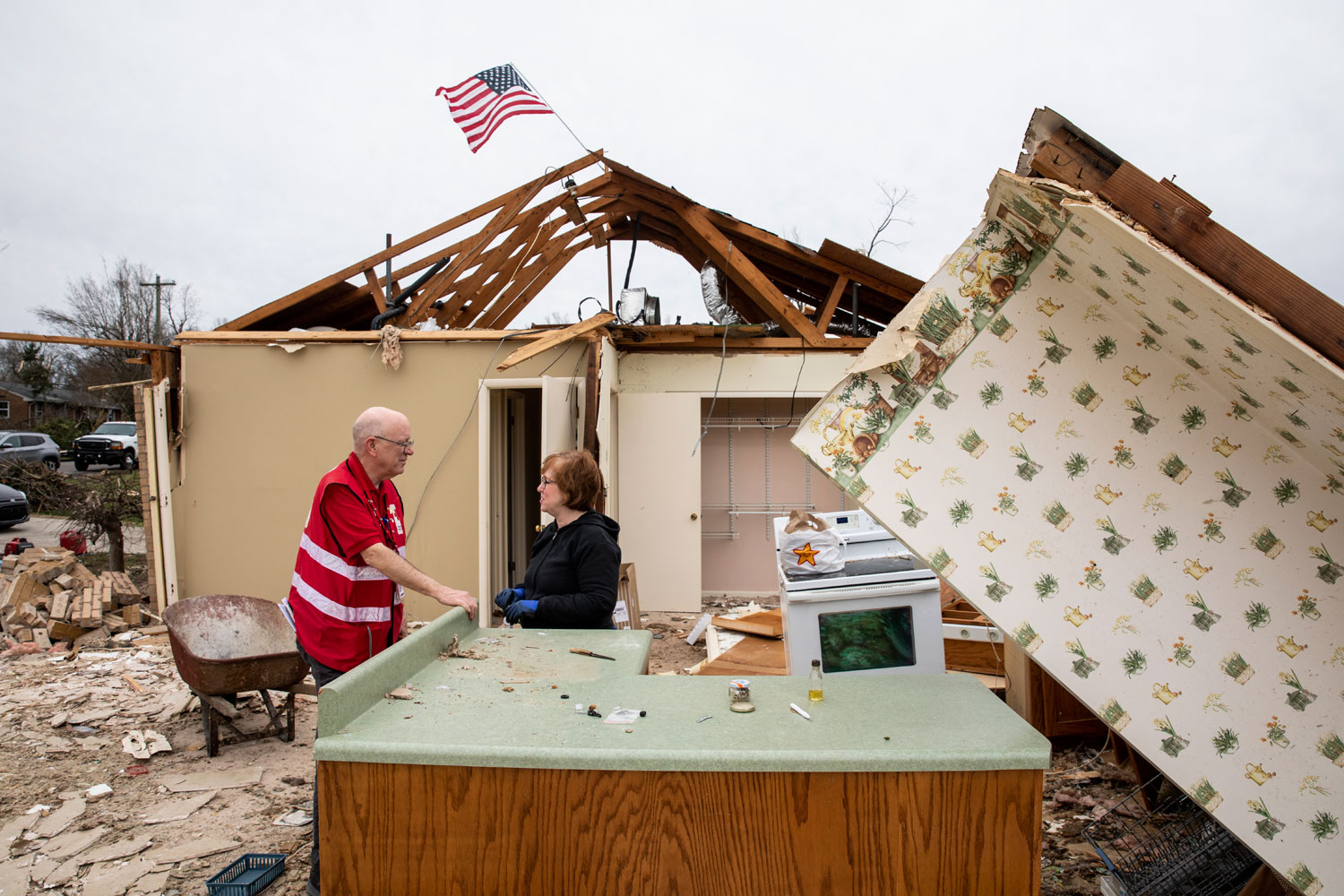 Red Cross volunteer discuss the damage