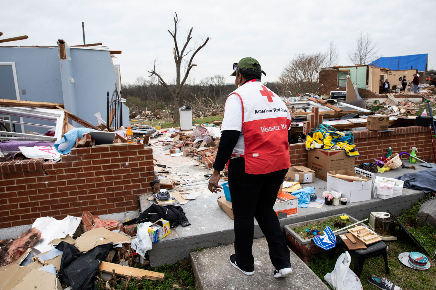 Red Cross volunteer surveys damage
