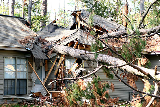 A home with major roof damage due to wind or tornado