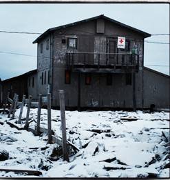 Red Cross office building in Alaska with a Red Cross banner hanging from an outdoor railing