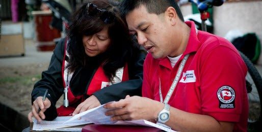 man and woman volunteer viewing papers