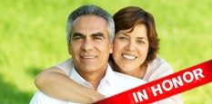 Woman with arm around man smiling for the camera.