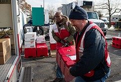 Red Cross volunteers load trucks with supplies for Superstorm Sandy victims