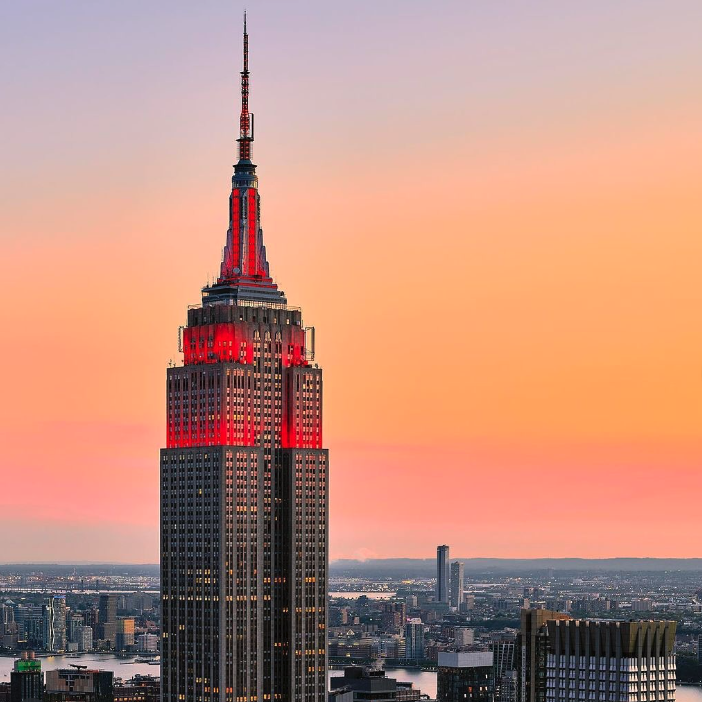 Empire State building lit up with red lights