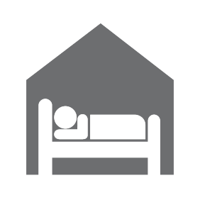 A man in bed at a shelter icon