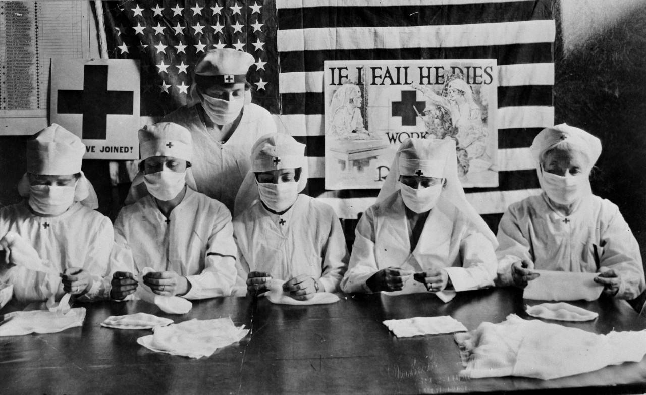 Butte, Montana, 1918. During World War I American Red Cross volunteer workers were busy in communities throughout the United States.  Warm garments and medical supplies for the "boys" up front were produced by volunteer hands in great quantities  This photo shows a typical group of volunteer workers making influenza face masks during the influenza epidemic.