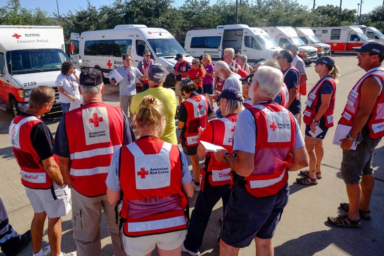 September 8, 2017. Sugar Land, Texas. Red Cross volunteers and Emergency Red Vehicle driver rather for the morning meeting Kitchen 11 in Sugar Land, Texas. Photo by Chuck Haupt for the American Red Cross 