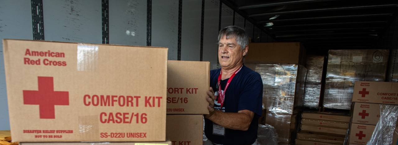 September 26, 2022. Orlando, Florida
Red Cross Fulfillment Team volunteers working ahead of Hurricane Ian, unload tractor trailers of supplies at the ESPN Center in Orlando, Fl. The goods will be heading to evacuation shelters all across Central Florida. The supplies include cots, blankets, gloves, flashlights and clean-up kits. The Fulfillment Team is working towards the Red Cross goal of supplying every need of every shelter every day. Team member Paul Duclos, from Greenwood, ME, was inspired to volunteer during Hurricane Harvey. "I went online to donate," he recalled, "and I saw the volunteer button on the website and clicked it. The next day they called, day after that we trained and the following day we were working at a shelter in Houston. My wife and I stayed there for three weeks and we've never looked back. I think in all, we've done 12 deployments."
Photo by Marko Kokic/American Red Cross