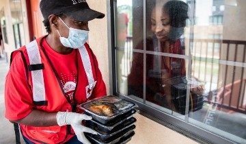 Red Cross volunteer carrying food