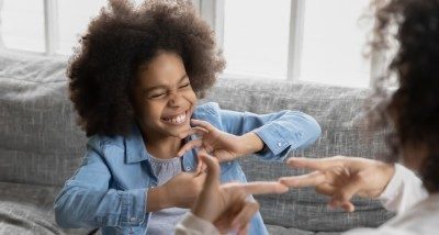 Young girl doing sign language 