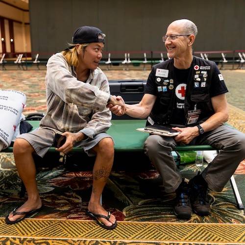rich byam shaking hands with client in shelter 