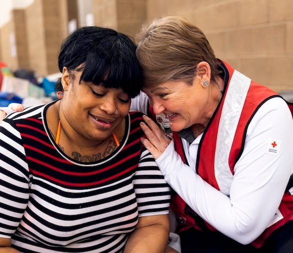Text reads Free Gift with donation while supplies last with a minimum donation of $140, with photos of a black, gray, and white monopack or a pair of red socks with the American Red Cross logo.