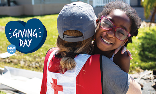 Mother holding her daughter near Red Cross vehicle